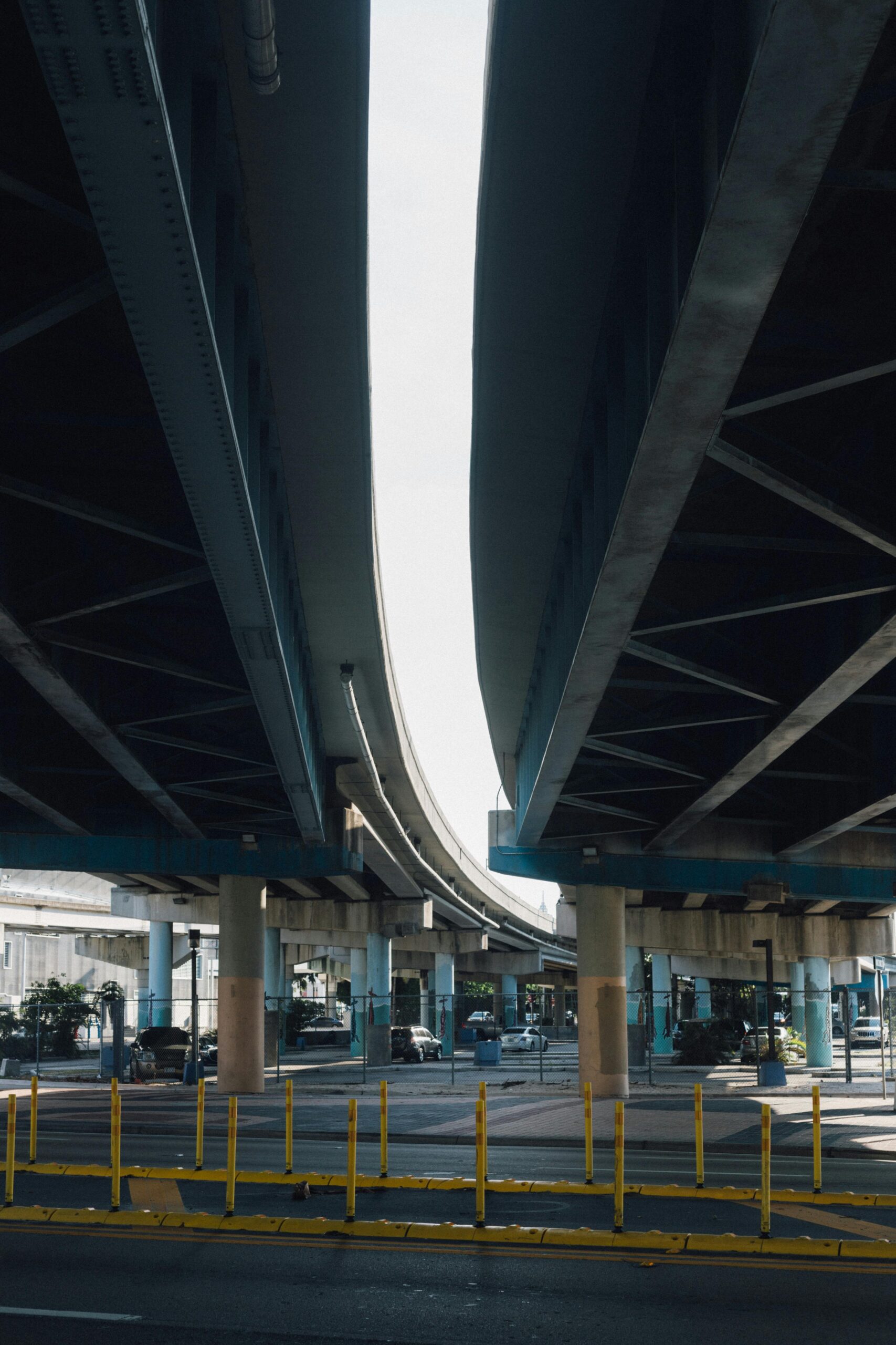 View of a modern urban overpass with vehicles and traffic below, captured in daylight.
